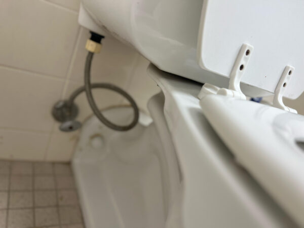 "Professional plumber fixing toilet and replacing toilet supply line in a 30A Florida home - expert plumbing services for Santa Rosa Beach, Seaside, Inlet Beach, Grayton Beach and surrounding areas."