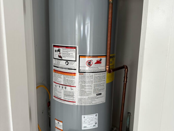Professional plumber replacing tanked water heater in a 30A Florida home - expert plumbing services for Santa Rosa Beach, Seaside, Watercolor, Rosemary and surrounding areas."